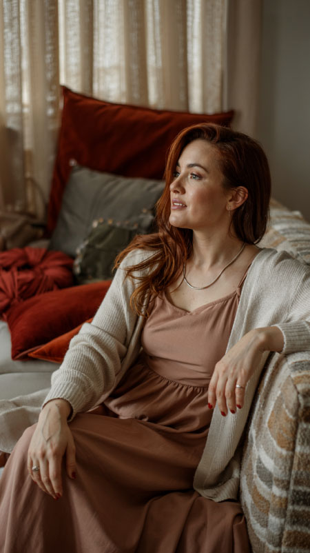 A flowy maxi dress in a muted floral or solid rust hue transitions beautifully from Thanksgiving dinner to evening relaxation. 