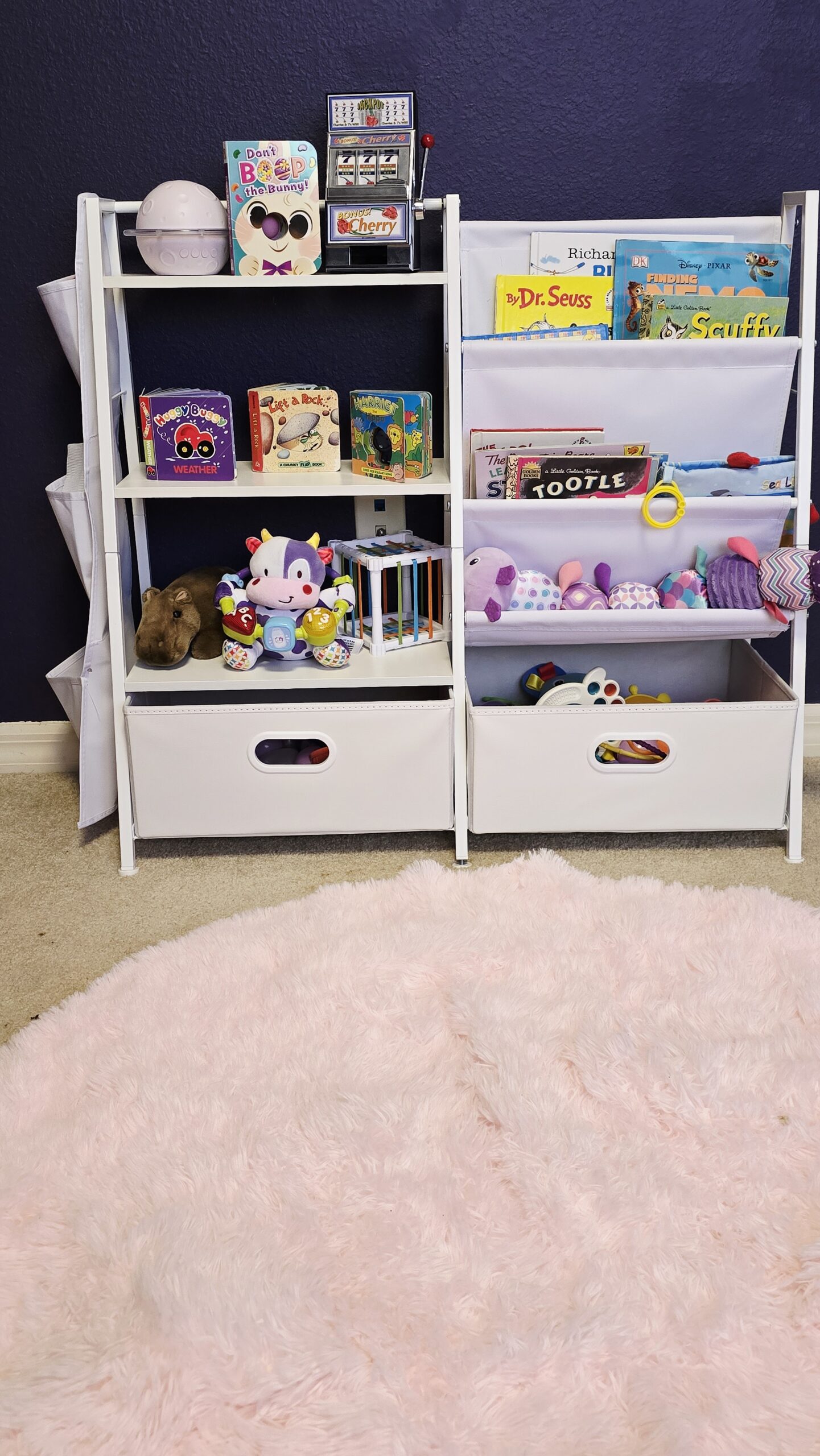 Kids bookshelf and toy storage organizer in girls room makeover with books, toys, and bins on a low child-safe shelving unit