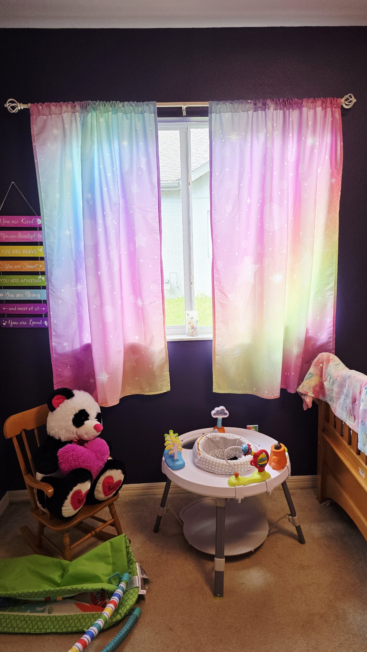 Rainbow curtains in girls room makeover with white curtain rod showing colorful window treatment and light blocking effect